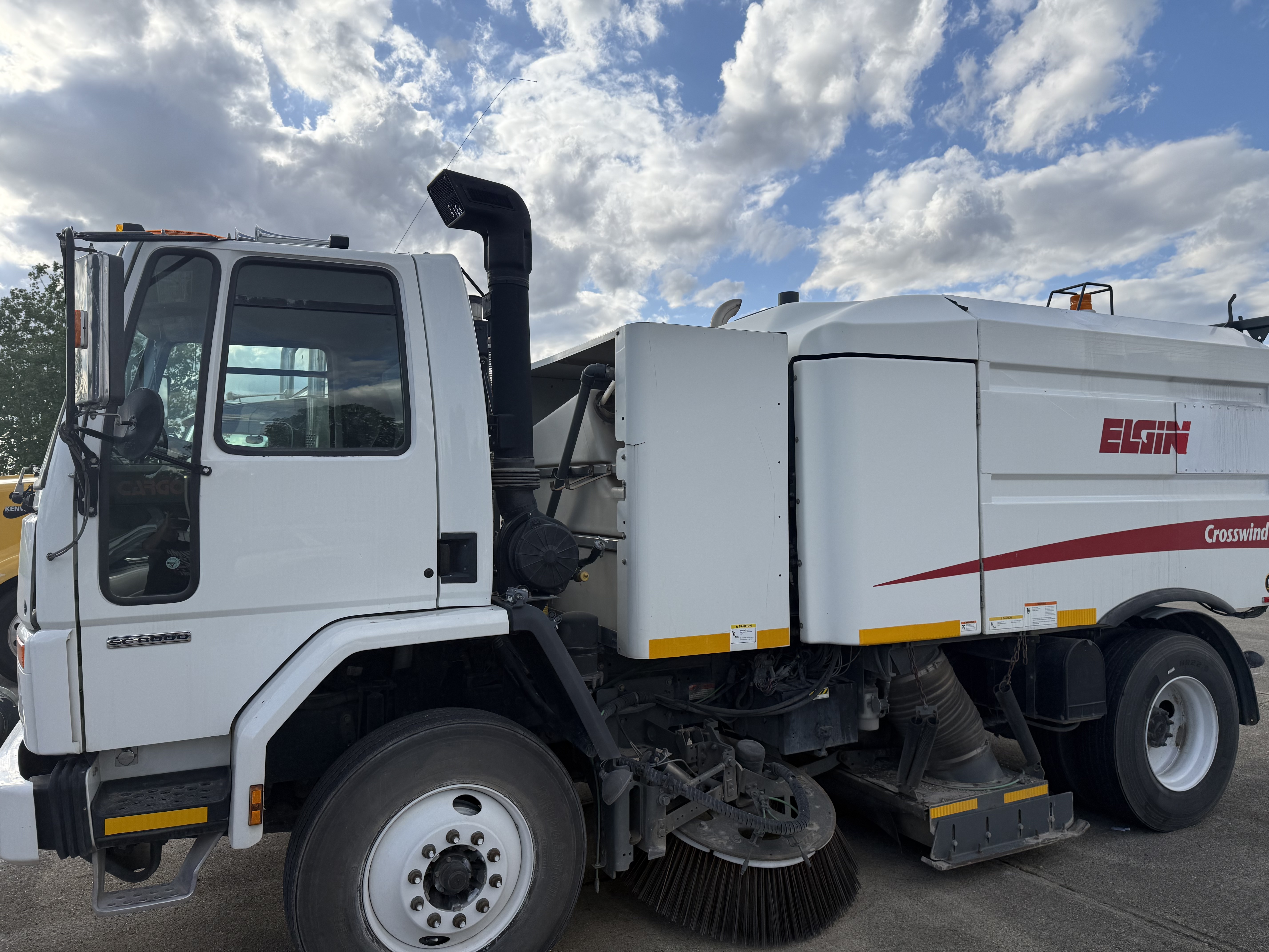 Industrial street sweeper in action
